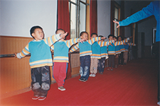 Children practicing movement and coordination in a group activity