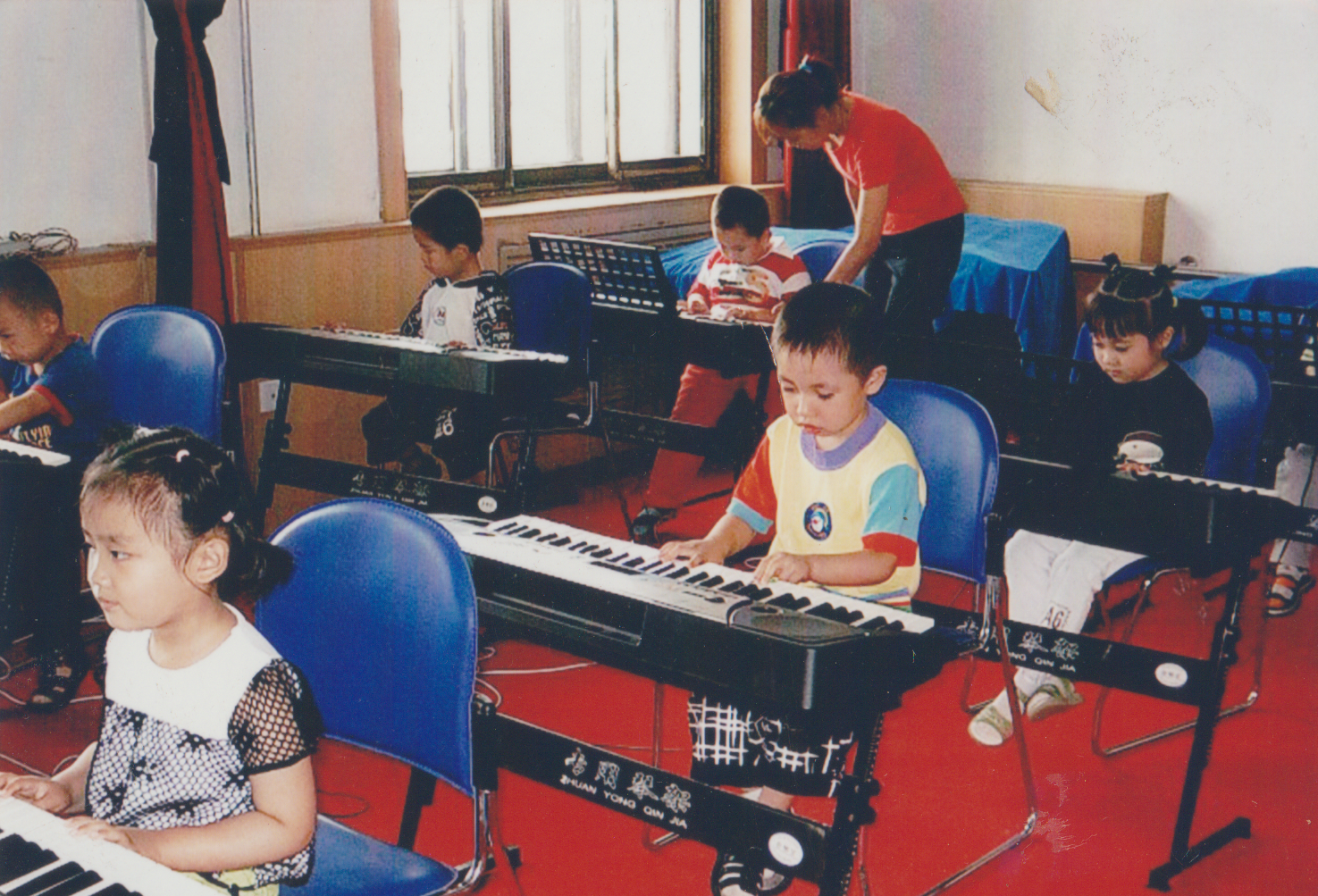 Children learning music with keyboards